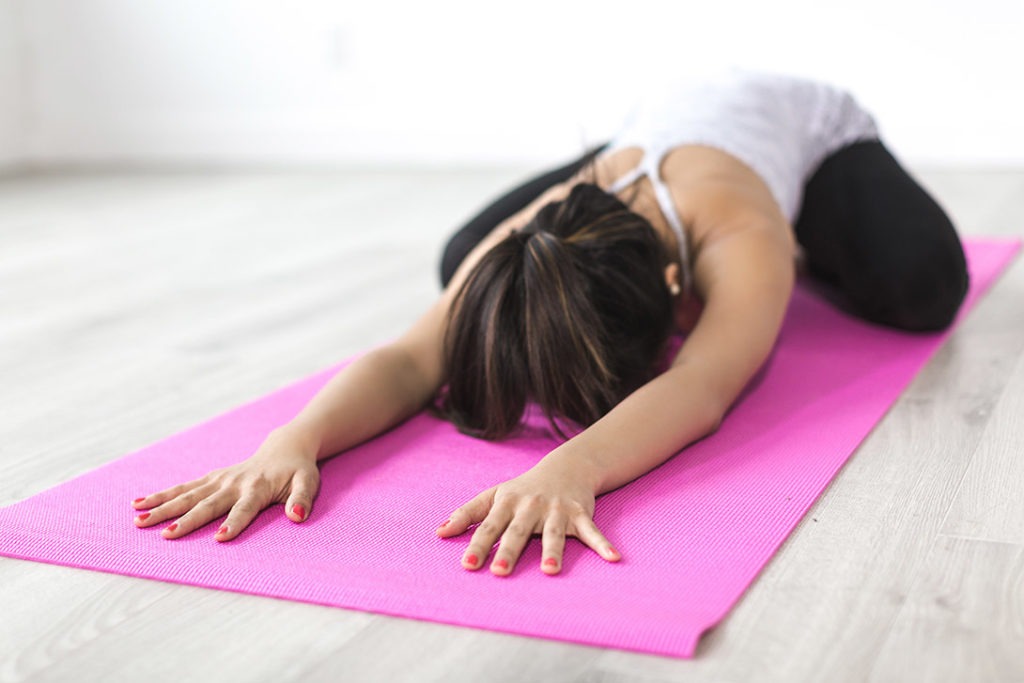 woman stretching post workout